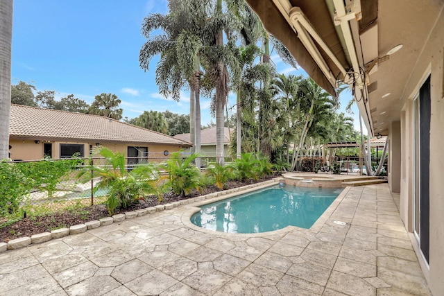 view of swimming pool featuring an in ground hot tub and a patio area