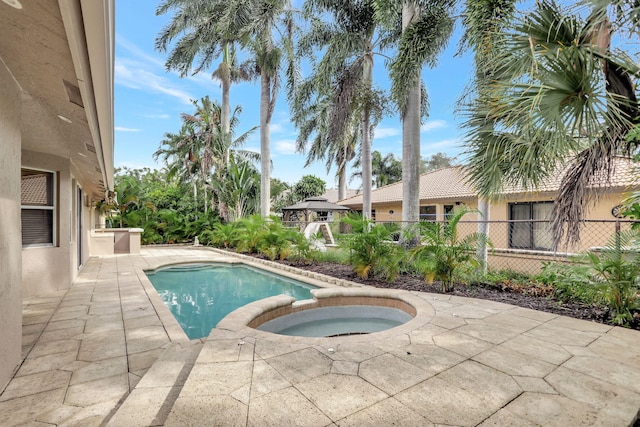 view of swimming pool featuring an in ground hot tub