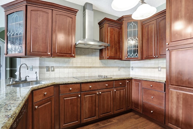 kitchen featuring dark wood-type flooring, wall chimney exhaust hood, a textured ceiling, sink, and backsplash