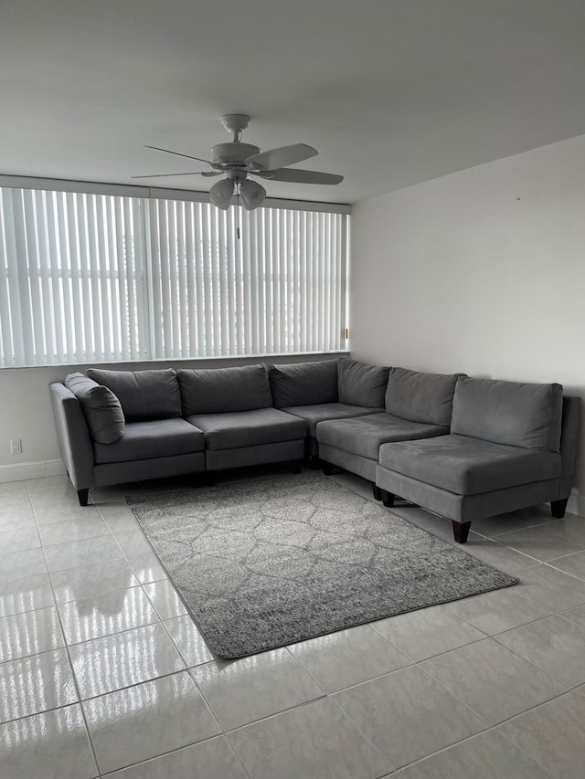 living room featuring light tile patterned floors and ceiling fan