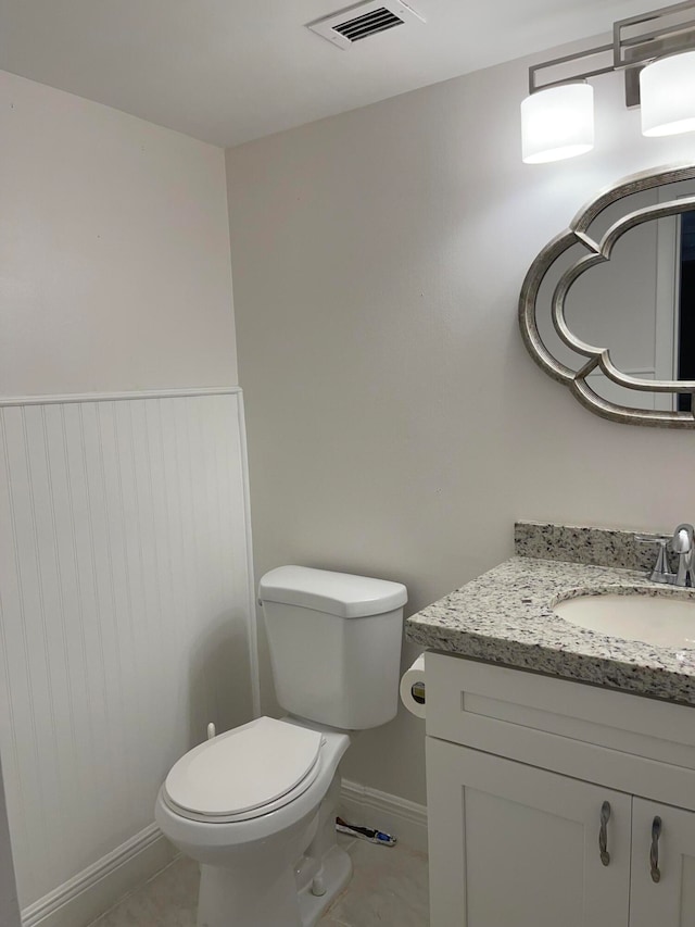 bathroom featuring tile patterned floors, vanity, and toilet