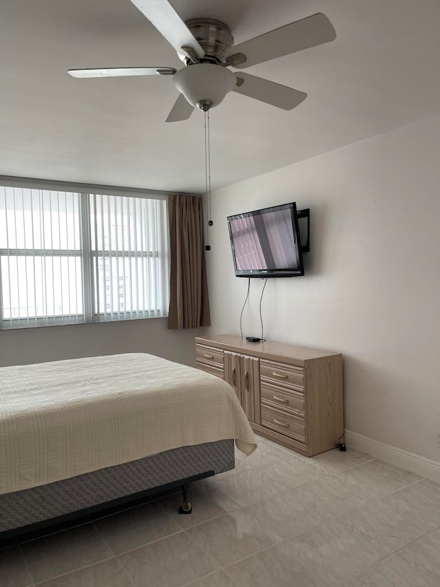 bedroom featuring ceiling fan and light tile patterned floors