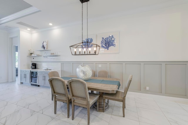 dining space featuring ornamental molding, wine cooler, and a chandelier