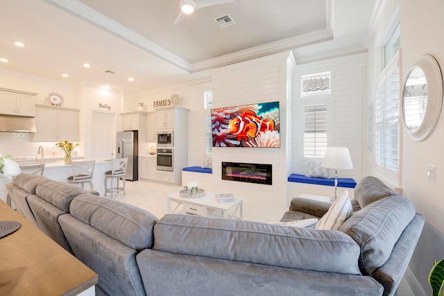 living room featuring plenty of natural light and ornamental molding