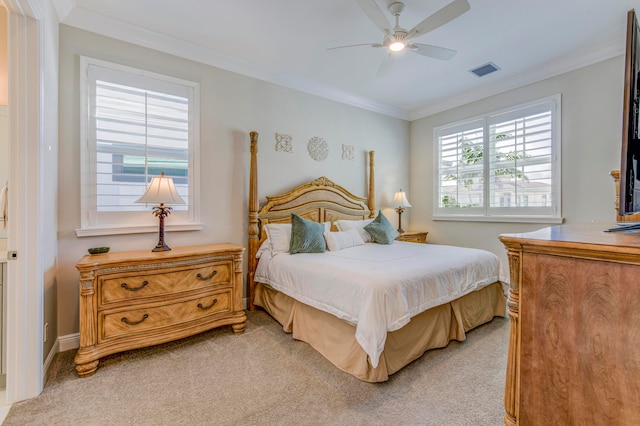 bedroom with ceiling fan, light colored carpet, and crown molding