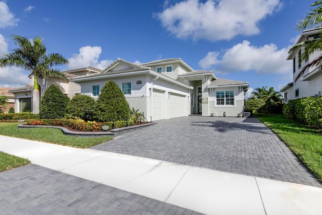 view of front of house featuring a garage and a front lawn