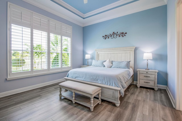 bedroom featuring hardwood / wood-style flooring, ceiling fan, and crown molding