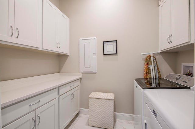 laundry area featuring cabinets and washing machine and dryer