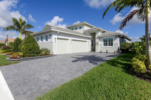 view of front of home with a front lawn and a garage