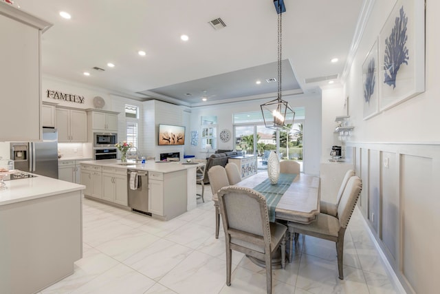 dining area with crown molding and sink