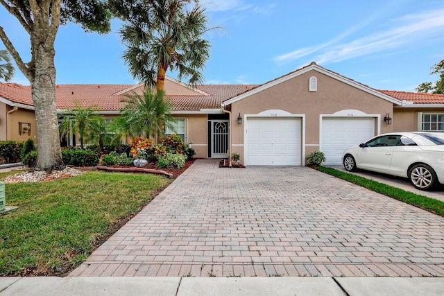 ranch-style home with a front lawn and a garage