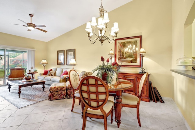 tiled dining space with ceiling fan with notable chandelier and high vaulted ceiling