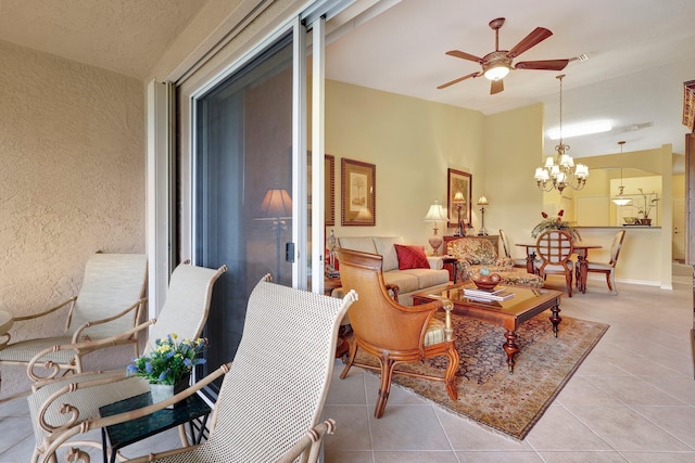 interior space featuring ceiling fan with notable chandelier, lofted ceiling, and light tile patterned floors