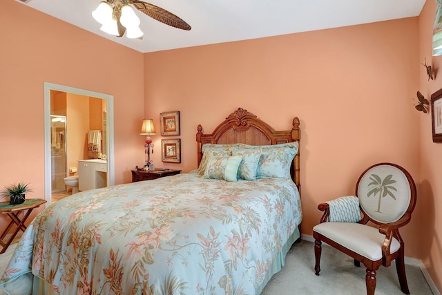 carpeted bedroom featuring connected bathroom and ceiling fan