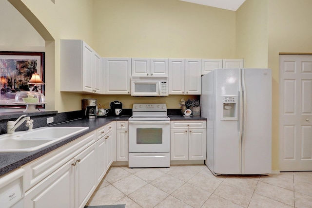 kitchen with white appliances, sink, high vaulted ceiling, white cabinetry, and light tile patterned flooring