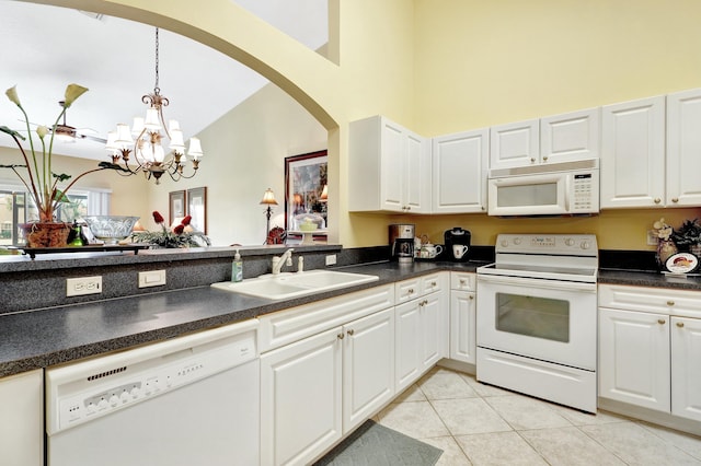 kitchen featuring hanging light fixtures, white appliances, light tile patterned floors, sink, and white cabinetry