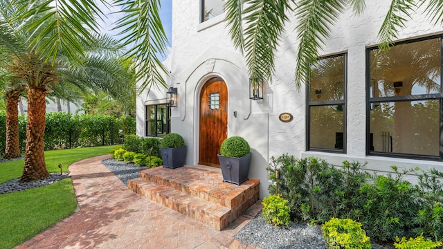 doorway to property with a lawn