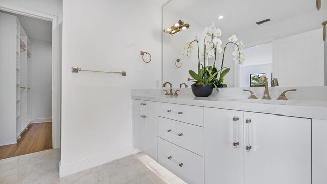 bathroom with vanity and a shower with door