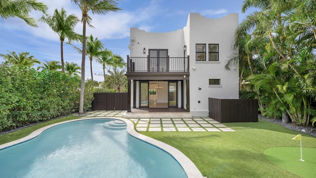 back of house featuring a balcony and a patio