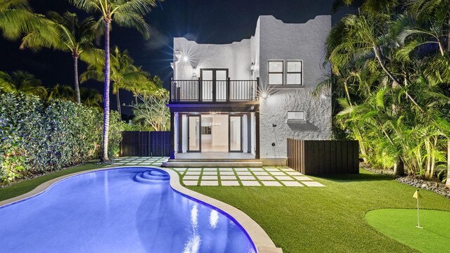 back of property featuring a patio and a balcony