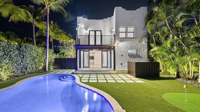 rear view of property with a balcony