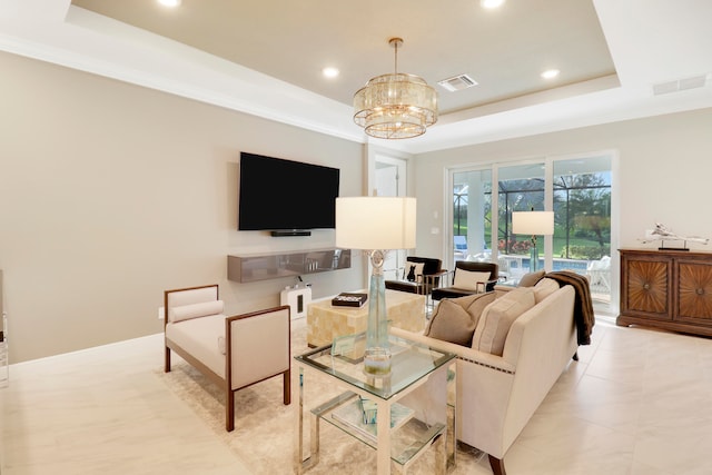 living room featuring a raised ceiling and a notable chandelier