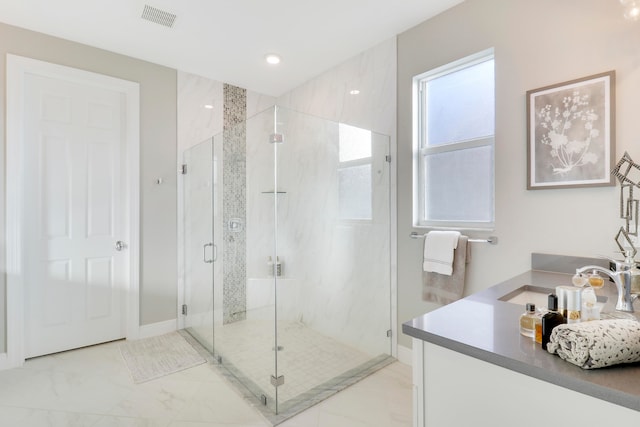 bathroom with vanity and a shower with shower door