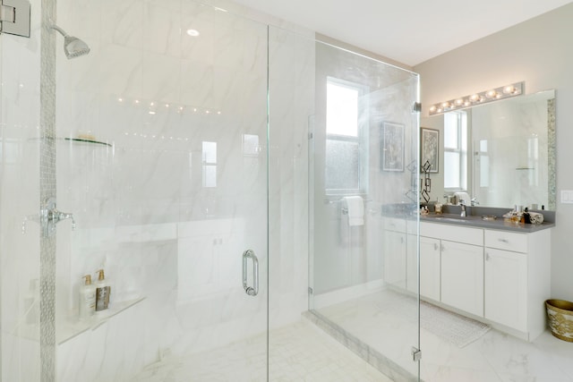 bathroom with vanity and a shower with shower door