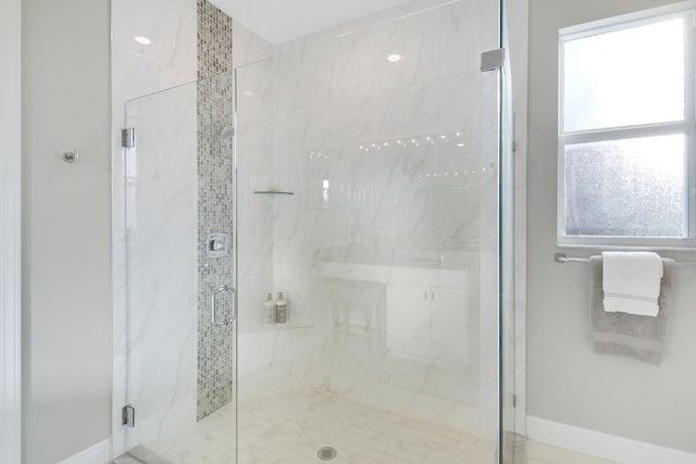 bathroom featuring a shower with shower door