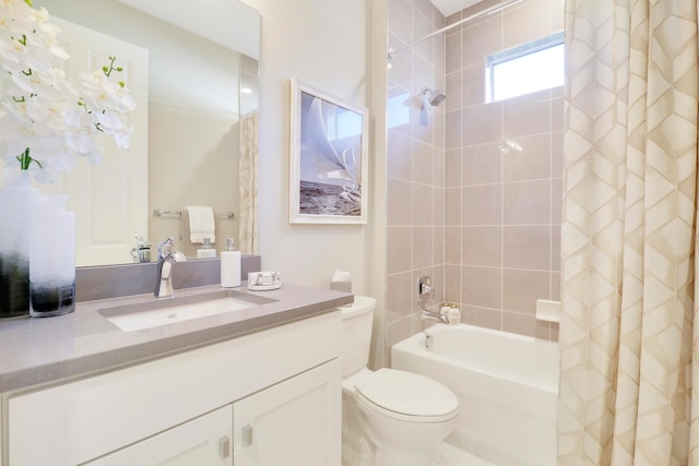 full bathroom featuring shower / bath combination with curtain, vanity, and toilet