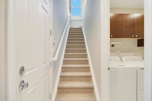 stairs featuring washing machine and dryer