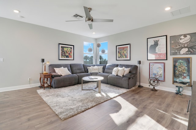 living room with light wood-type flooring and ceiling fan