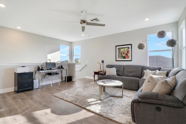 living room with ceiling fan and light hardwood / wood-style floors