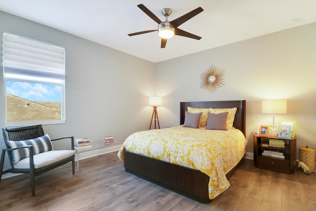 bedroom featuring hardwood / wood-style flooring and ceiling fan