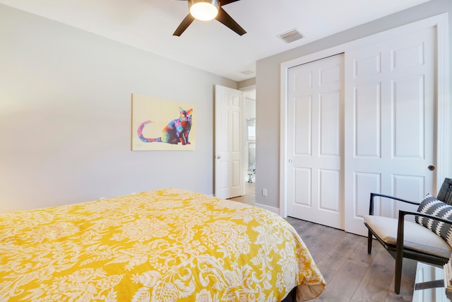 bedroom featuring ceiling fan, a closet, and light hardwood / wood-style floors