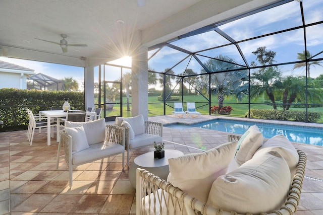 view of patio / terrace with glass enclosure, ceiling fan, and an outdoor living space