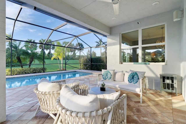 view of pool featuring a patio, glass enclosure, and ceiling fan