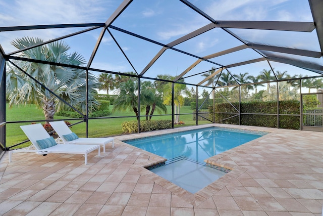 view of pool featuring glass enclosure, a patio area, and a yard