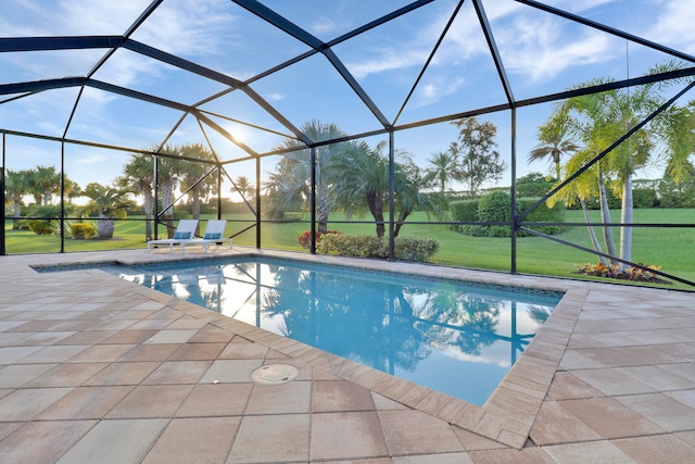 view of pool with a lawn, a lanai, and a patio