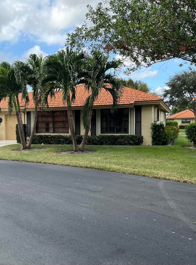 ranch-style home with a front lawn