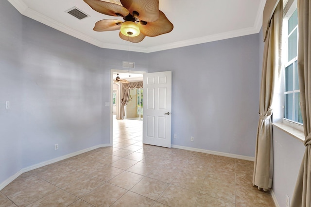 tiled empty room featuring ceiling fan, plenty of natural light, and ornamental molding