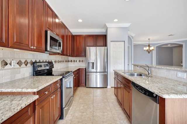 kitchen with decorative backsplash, pendant lighting, and stainless steel appliances