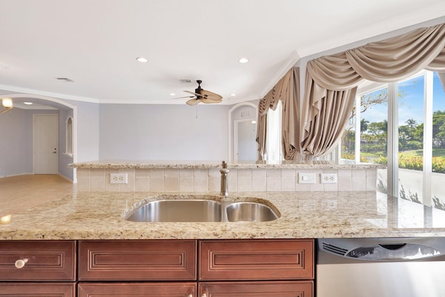 kitchen featuring backsplash, dishwasher, sink, and ornamental molding