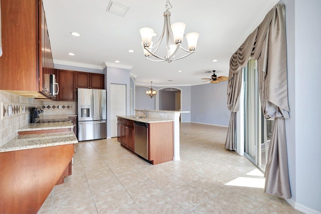 kitchen featuring backsplash, stainless steel appliances, ceiling fan, crown molding, and decorative light fixtures