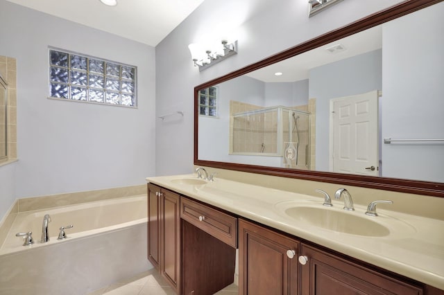 bathroom featuring tile patterned flooring, shower with separate bathtub, and vanity