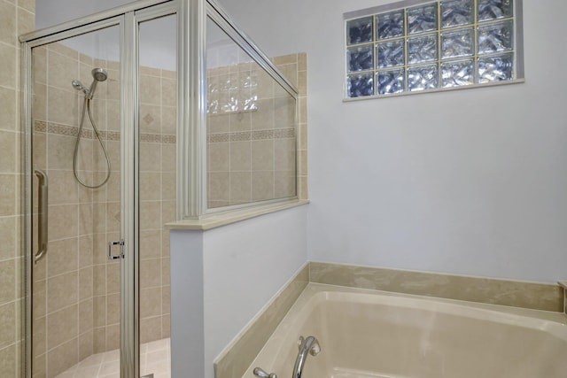 bathroom with shower with separate bathtub