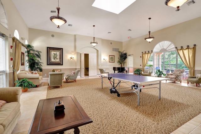 game room featuring a towering ceiling