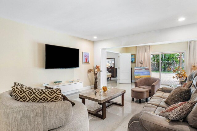 living area with light tile patterned floors, baseboards, visible vents, and recessed lighting