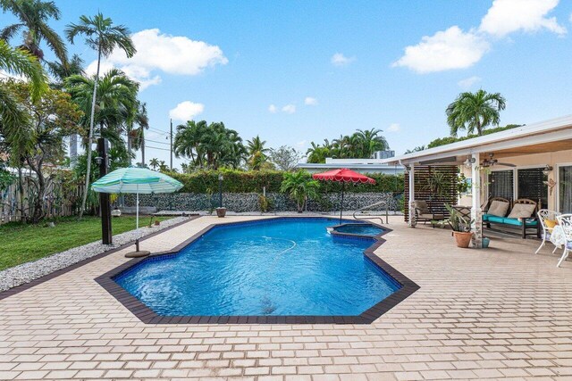 single story home with decorative driveway, a tiled roof, a front lawn, and stucco siding