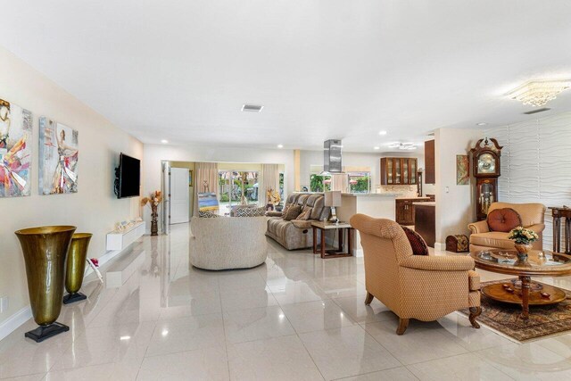 living room with recessed lighting, visible vents, and wallpapered walls